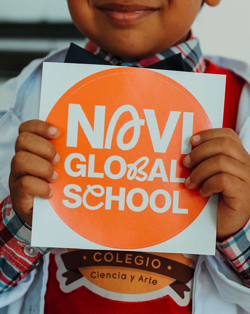 expo_feed_0008_9 1 Child holding a Navi Global School sign